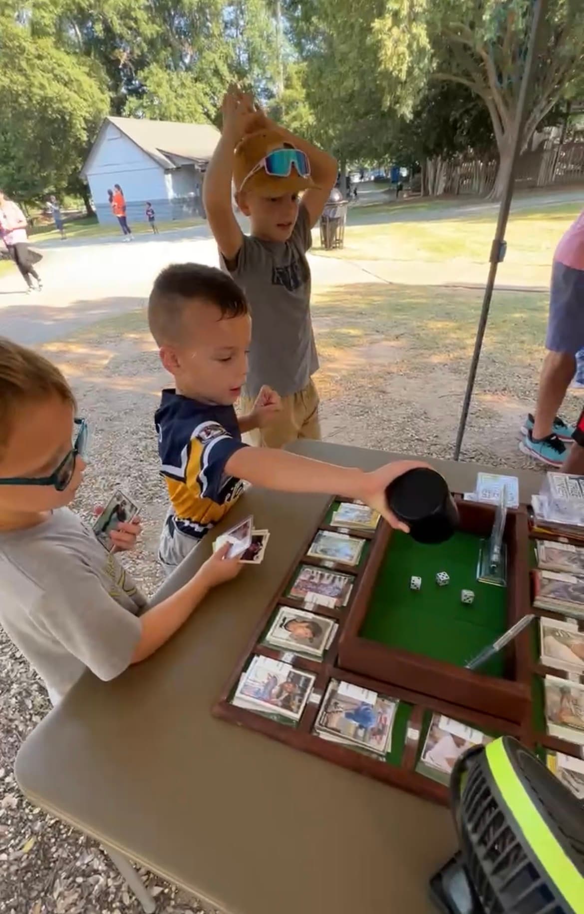A pack of cards changing hands to a kid.