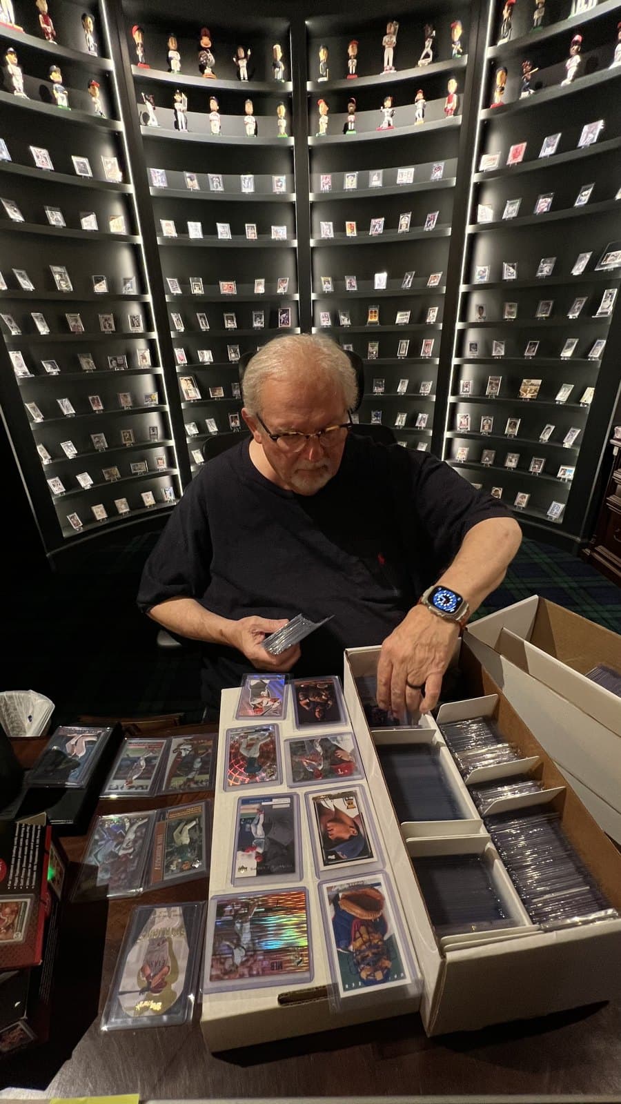 The CardFather sorting cards at the table.