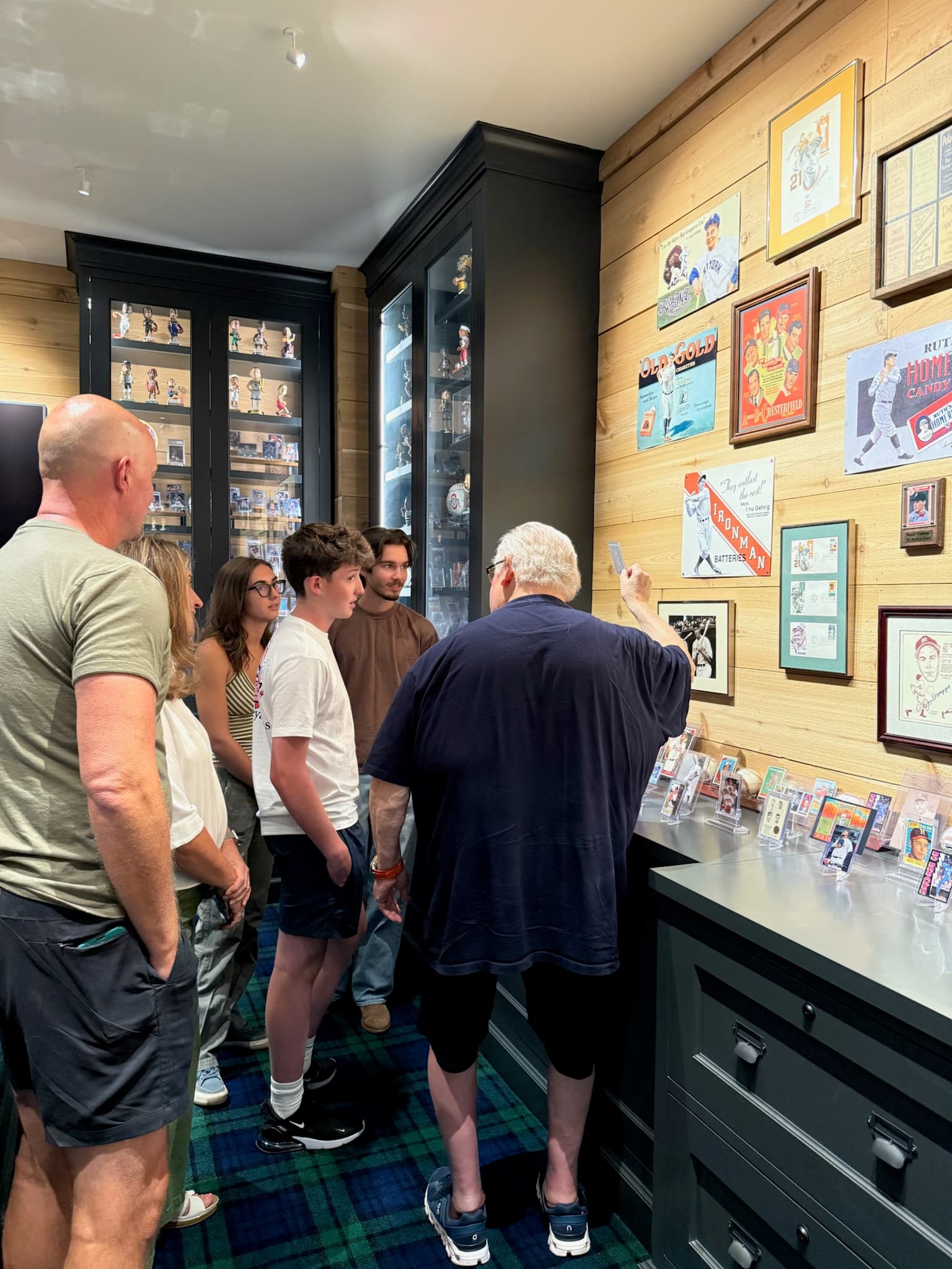 The CardFather showing a card to visitors in the card room.